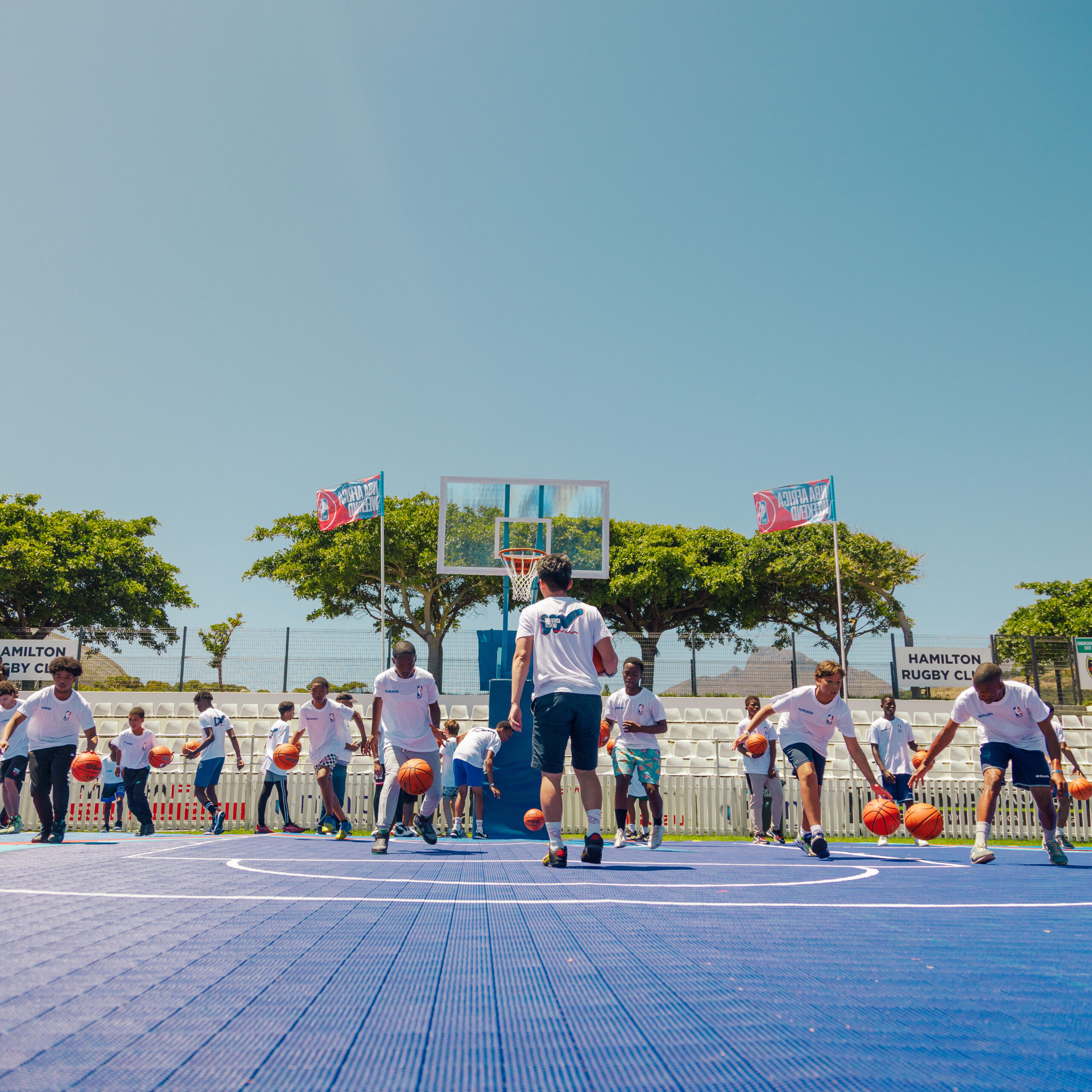 Youth participating in the clinic wotking on their ball handling and skills development